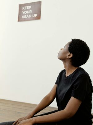 A young woman looking up at an inspiring message on the wall.