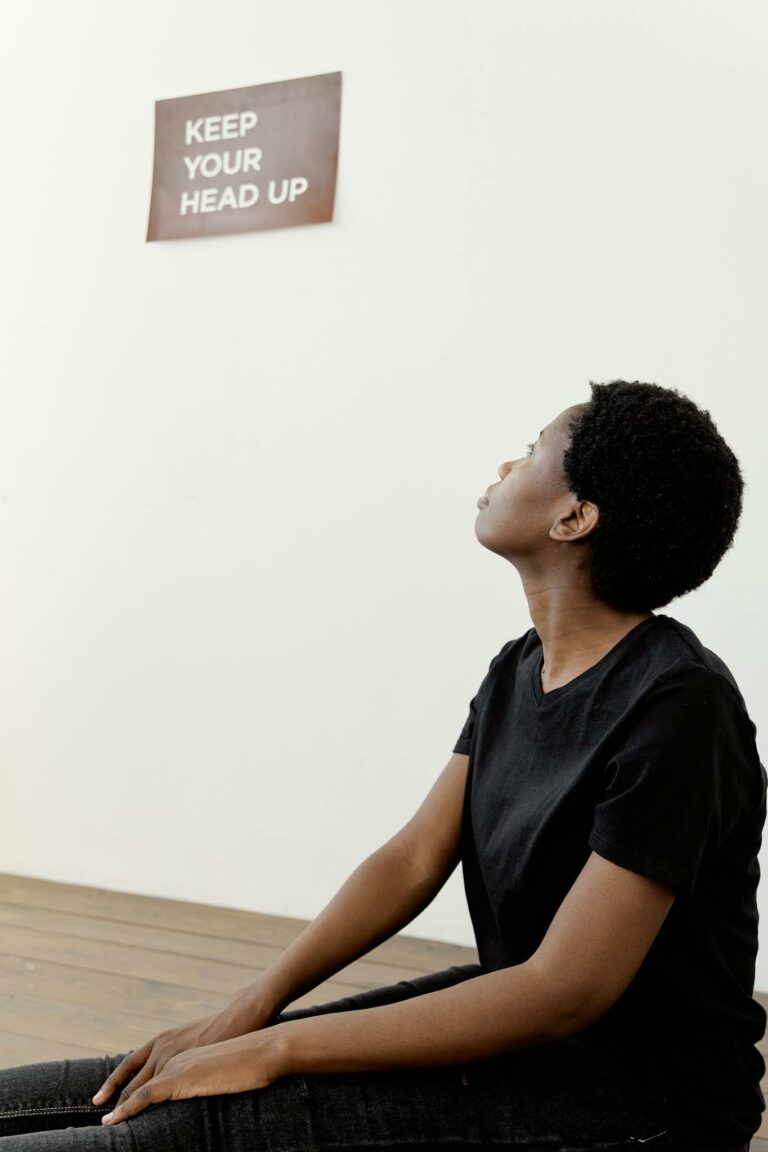 A young woman looking up at an inspiring message on the wall.